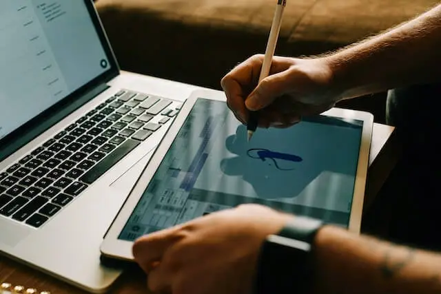 A designer drawing on his tablet.